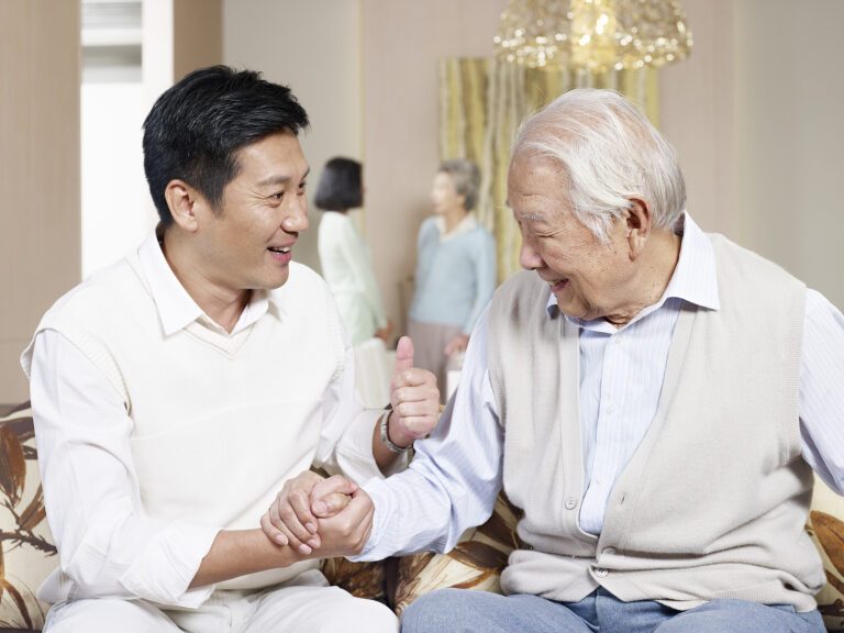 Asian Father and Son Discussing Power of Attorney Services