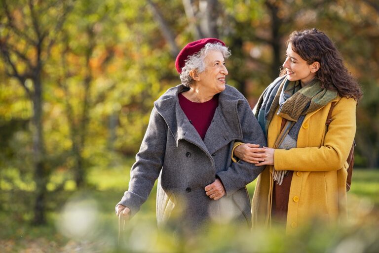 Young Woman with Grandmother in Park Discussing Power of Attorney